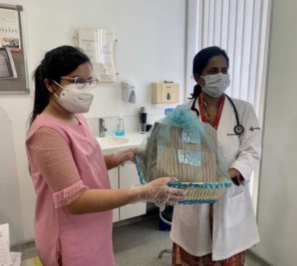 Handing teacakes to a doctor