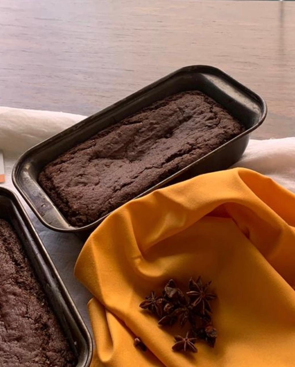 A loaf of whole wheat banana bread in a baking tin