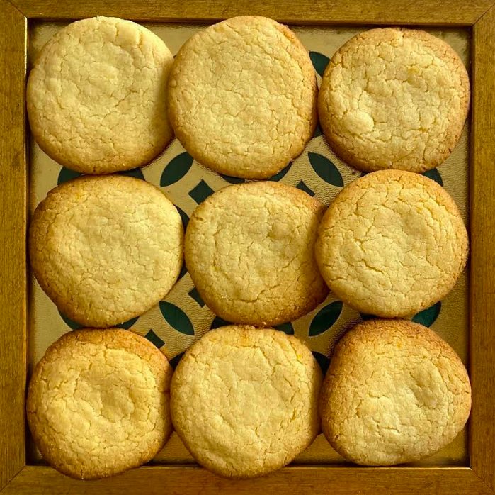 Golden shortbread cookies arranged in a box